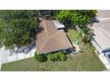 Aerial view of the single-Gathering home featuring a fenced backyard with seating at 1711 N Highland Ave, Clearwater, FL 33755