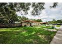 Inviting single-story home featuring a lush green lawn, pathway, and tidy landscaping, creating a welcoming exterior at 1893 Harding St, Clearwater, FL 33765