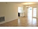 The open-concept layout is enhanced by tile flooring and is complemented by an elegant chandelier and lots of light at 201 Faithway Dr, Seffner, FL 33584