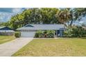 Charming single-story home with a well-maintained lawn, mature landscaping, and an attached two-car garage at 23067 Brighton Pl, Land O Lakes, FL 34639