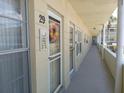 View of hallway of unit #29 with exterior doors, a floral wreath, and view of the parking lot at 2459 Franciscan Dr # 29, Clearwater, FL 33763