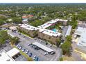 Aerial view of condo building, showing parking, carports and community pool at 2525 W Bay Dr # A46, Largo, FL 33770
