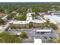 Aerial view of condo building shows parking and mature trees at 2525 W Bay Dr # A46, Largo, FL 33770