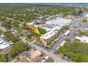 Aerial view of the condo shows the building and parking area, surrounded by mature trees at 2525 W Bay Dr # A46, Largo, FL 33770