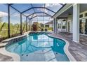 Relaxing screened-in pool and spa area with brick-paved patio and playhouse at 2812 Long Bow Way, Odessa, FL 33556