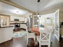 Dining area featuring dark hardwood floors and stainless steel appliances in the kitchen at 3354 52Nd N St, St Petersburg, FL 33703