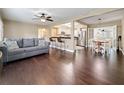 Open-concept living area with hardwood floors, a gray sofa, and bar seating near the kitchen at 3354 52Nd N St, St Petersburg, FL 33703