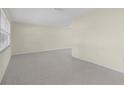 Spacious and bright living room featuring neutral walls, a window, and carpeting at 358 Highland Shores Dr, Ellenton, FL 34222