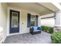Inviting front porch featuring a cozy seating area and stylish decor at 3800 Night Star, Odessa, FL 33556