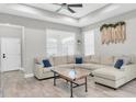 Spacious living room with a modern ceiling fan and plenty of natural light at 3800 Night Star, Odessa, FL 33556