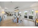 Dining room showcasing a modern light fixture and views of the outdoor patio and waterfront at 3956 Versailles Dr, Tampa, FL 33634