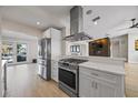 Bright kitchen features stainless steel appliances, white countertops, and an open layout connecting to the living space at 3956 Versailles Dr, Tampa, FL 33634