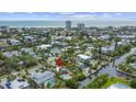 Stunning aerial view of the waterfront home in a coastal community, with a swimming pool and canal access at 451 Avenida De Mayo, Sarasota, FL 34242