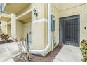 Side view of the entrance, featuring a private garage and an exterior door with security bars at 5521 Yellowfin Ct, New Port Richey, FL 34652