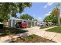 Well-maintained single-story home with lush green trees and landscaping in a suburban setting at 5895 16Th N St, St Petersburg, FL 33703