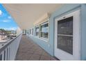 Hallway showing unit entrance, tile floors and patio railing, with scenic outdoor views at 6161 Gulf Winds Dr # 347, St Pete Beach, FL 33706