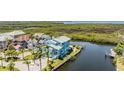 Aerial view showcases a home with waterside access, surrounded by mature landscaping at 6186 Seaside Dr, New Port Richey, FL 34652