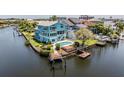 An aerial view showing a home with a private pool and dock along a waterway at 6186 Seaside Dr, New Port Richey, FL 34652
