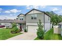 Attractive two-story home boasting a green lawn and a convenient two-car garage at 6248 Bradford Woods Dr, Zephyrhills, FL 33542