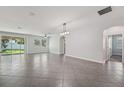 Spacious living room features tile flooring, sliding glass doors, and lots of natural light at 6706 Riverside Bluffs Dr, Riverview, FL 33578