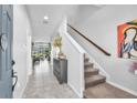 Inviting foyer with tile flooring leading to a carpeted staircase and view of living room at 7124 Summer Holly Pl, Riverview, FL 33578