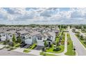 Neighborhood aerial view showcasing meticulously designed homes, lush landscaping and a well maintained community at 7517 Notched Pine Bnd, Wesley Chapel, FL 33545