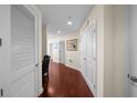 Bright hallway featuring wood floors, neutral walls, and multiple doors leading to rooms at 777 N Ashley Dr # 1903, Tampa, FL 33602