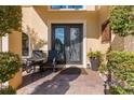 Elegant front entrance featuring double doors, a cozy seating area, and tasteful decor at 8358 Dunham Station Dr, Tampa, FL 33647