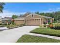 Charming single Gathering home with a double garage, manicured lawn, and curb appeal at 8624 Snowy Owl Way, Tampa, FL 33647