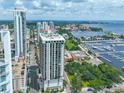 Stunning aerial view highlighting a modern residential tower near a picturesque marina and bay, with city skyline views at 1 Beach Se Dr # 811, St Petersburg, FL 33701