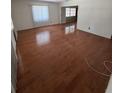 Bright living room featuring hardwood floors and natural light from a large window at 11423 77Th Ave, Seminole, FL 33772