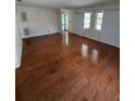 Spacious living room featuring hardwood flooring, bright natural light, and a welcoming atmosphere at 11423 77Th Ave, Seminole, FL 33772