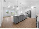 Spacious kitchen with a large island, stainless steel appliances, and an open view to the living area at 115 White Marsh Ln, Rotonda West, FL 33947