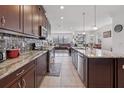 Modern kitchen with granite countertops, stainless steel appliances, and views to the living area at 11617 Crowned Sparrow Ln, Tampa, FL 33626