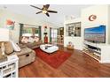 Bright living room featuring hardwood floors, neutral paint, and comfortable seating at 12337 Rose Haven Blvd, New Port Richey, FL 34654