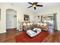Open living room showcasing hardwood floors, cozy sofas, and natural light at 12337 Rose Haven Blvd, New Port Richey, FL 34654