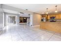 Bright, open floorplan with large tiled floors, a living room and a kitchen at 13702 Sweetwater Cove Pl # 25, Tampa, FL 33613
