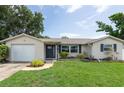 Well-maintained home with a front yard featuring shrubs and mulch-filled garden beds at 1806 11Th Sw St, Largo, FL 33778