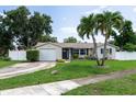 Inviting single-story home with a circular driveway and palm trees in the front yard at 1806 11Th Sw St, Largo, FL 33778