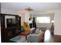 Spacious living room featuring hardwood floors, fireplace, and a large window at 2101 Sunset Point Rd # 2304, Clearwater, FL 33765