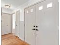 Bright foyer features a closet and hardwood floors, creating an inviting entrance at 2233 Curlew Rd, Dunedin, FL 34698