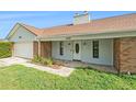 Inviting single-story home featuring a well-manicured lawn, garage, and covered front entry at 2308 Long Green Ct, Valrico, FL 33596