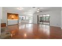 Spacious living room featuring hardwood floors, modern lighting, and a seamless flow to the patio at 2308 Long Green Ct, Valrico, FL 33596