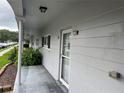 Unit exterior with a covered porch and a view of a grassy common area at 2410 Franciscan Dr # 18, Clearwater, FL 33763