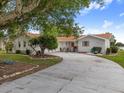 Well-kept home featuring mature trees, ample parking and partial water view at 2436 Nuremberg Blvd, Punta Gorda, FL 33983