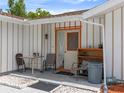 Outdoor patio with table, chairs, storage shelves and entry door at 2436 Nuremberg Blvd, Punta Gorda, FL 33983