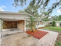 Welcoming single-story home featuring a covered carport and landscaped front yard at 307 Fern Cliff Ave, Temple Terrace, FL 33617