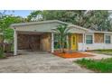 Inviting single-story home with a covered carport and attractive stone detailing at 307 Fern Cliff Ave, Temple Terrace, FL 33617