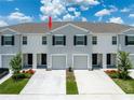 A lovely row of two-story townhomes is viewed from an elevated vantage point at 33063 Tulip Petal Ln, Wesley Chapel, FL 33545