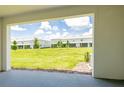 A covered patio offers views of the community lawns and landscaping at 33063 Tulip Petal Ln, Wesley Chapel, FL 33545